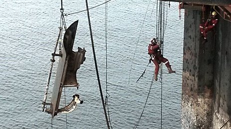 Rope-access work over open water quay wall